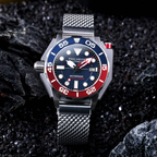 Watch with a red and blue bezel on a dark textured background