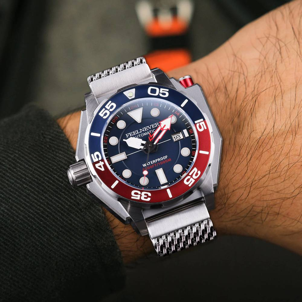 Wrist wearing a watch with a blue and red face on a blurred background
